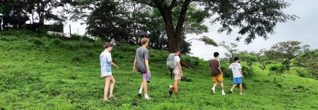 five students walking on a hillside in Panama