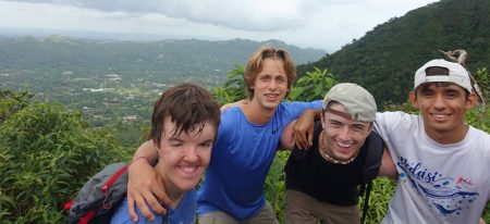 four students smiling on top of a hill in Panama