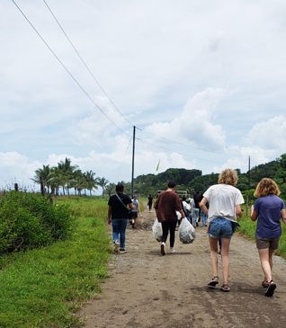 students walking on a dirt road