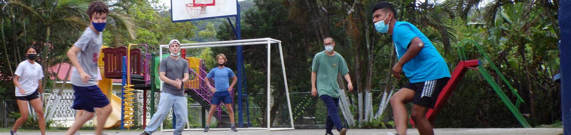 students playing soccer with masks on
