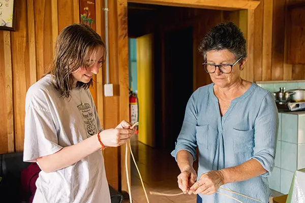 Volunteer learning local basketry techniques