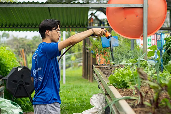 AMIGOS volunteer working on a greenhouse