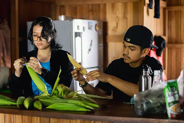 Volunteers peeling corn