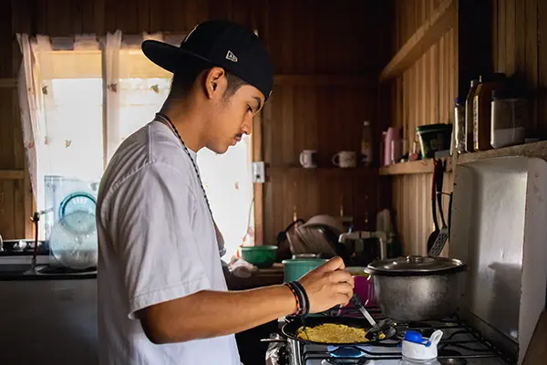 Volunteer cooking at his host home