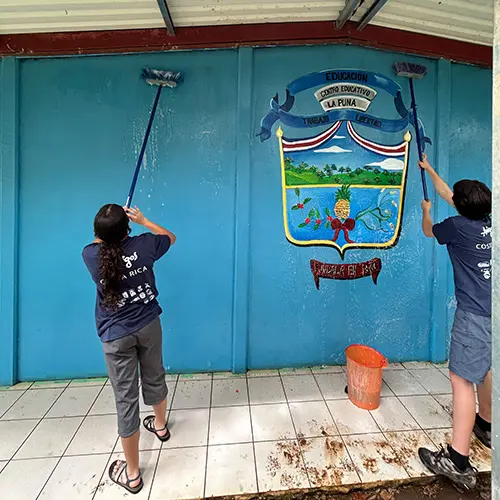Volunteers painting a wall