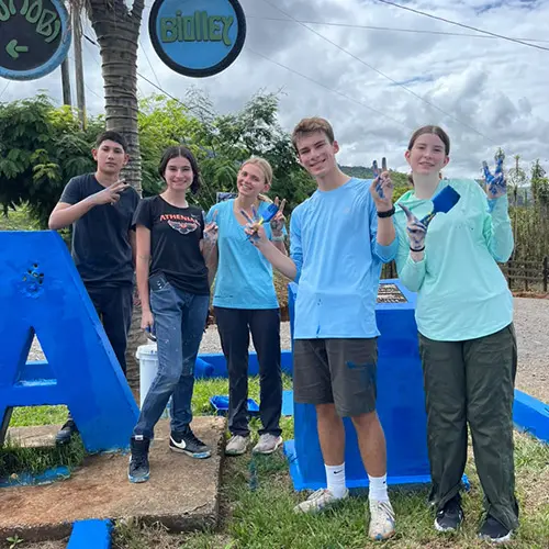 Volunteers doing painting service work