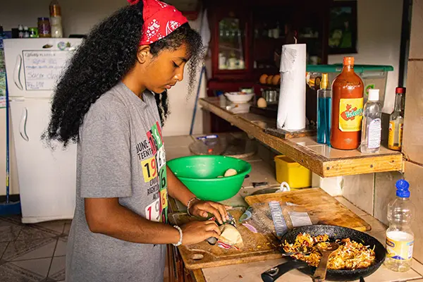 Volunteer preparing food in a host family kitchen