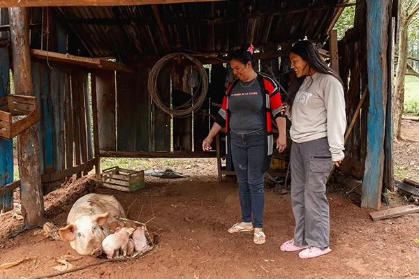Volunteer with her host mom looking at her farm animals