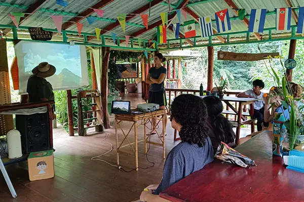 Volunteers learning from a partner agency representative