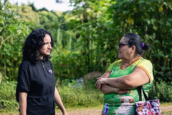 AMIGOS staff talking with a local community member