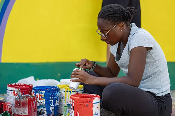 Volunteer mixing paint