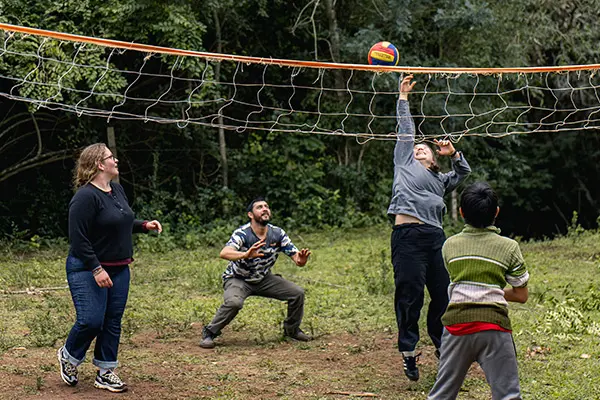 Volunteers playing volleyball in community