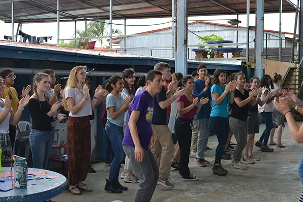 Volunteers and local youth participating in a group activity