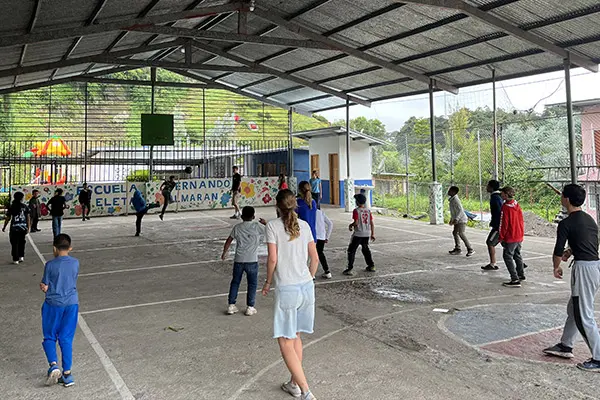 Volunteers playing with kids and youth in local court