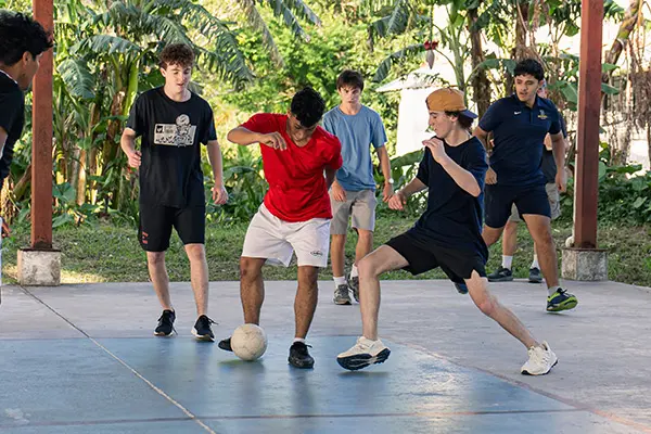 Volunteers playing soccer with local youth
