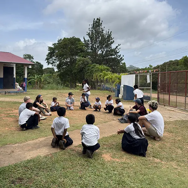 Volunteers leading a game for local kids