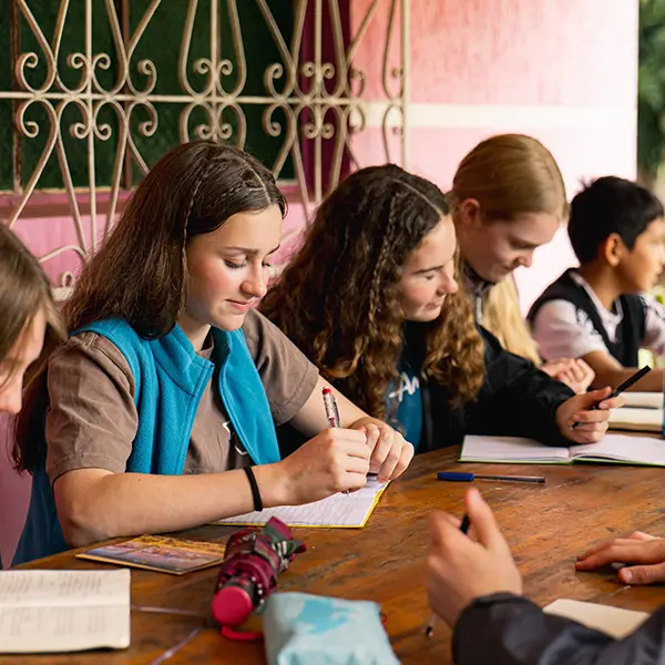 Volunteers participating in a workshop writing in their journals