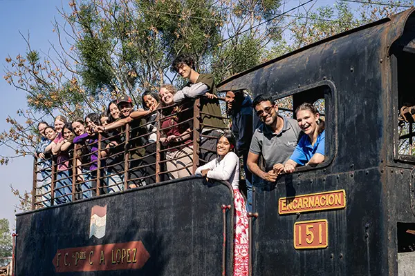 Volunteers and staff gathered together on a vintage train during a group field trip