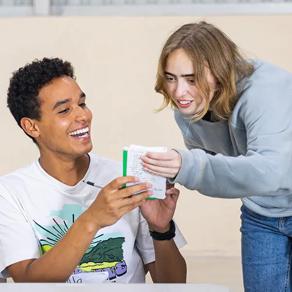 AMIGOS staff member providing feedback and guidance to a volunteer during an activity