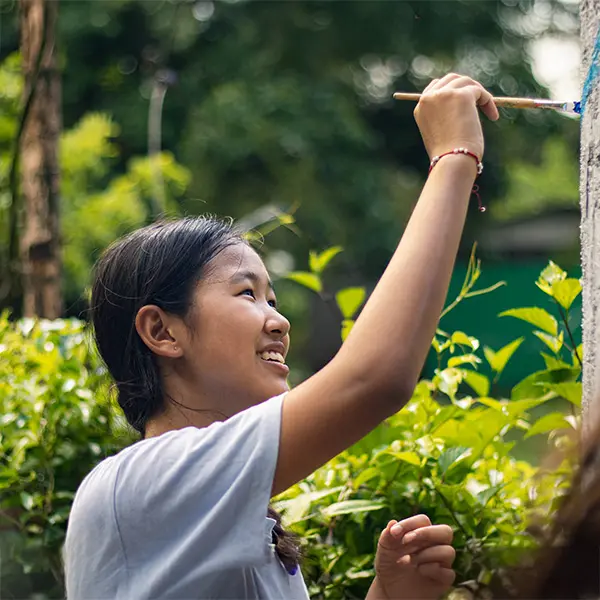 Volunteer painting a column