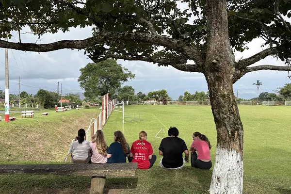 Volunteers sitting by a soccer field