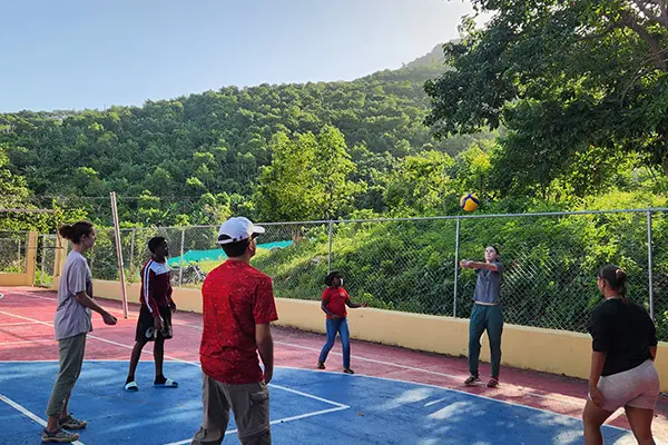 AMIGOS volunteers and local youth playing volleyball