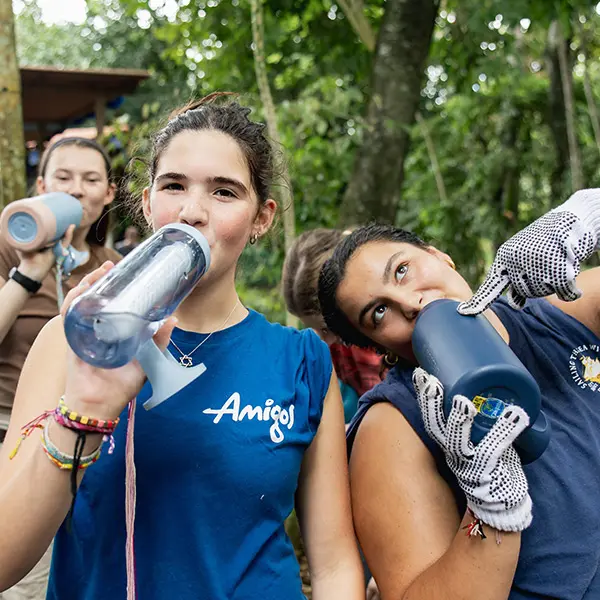 Volunteers staying hydrated and drinking water together during outdoor work