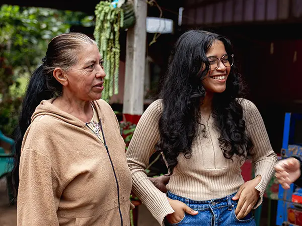 Volunteer and her local host mother sharing a friendly moment outdoors