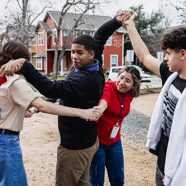 Young volunteers untangling a "human knot" during a group exercise
