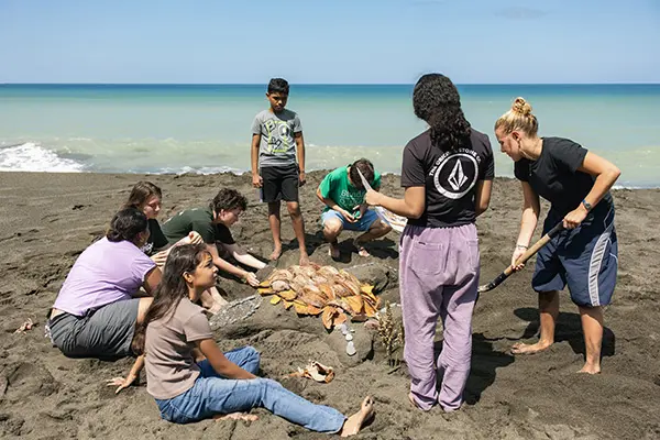 Volunteers making sand sculptures with local youth