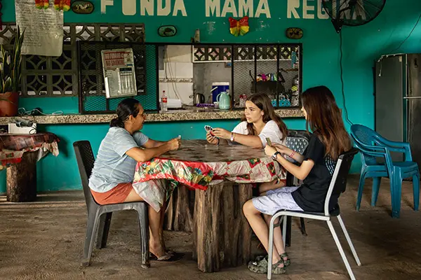 AMIGOS volunteers playing cards with their host mom