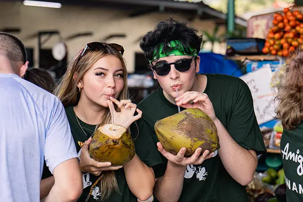 Volunteers enjoying a fresh coconut