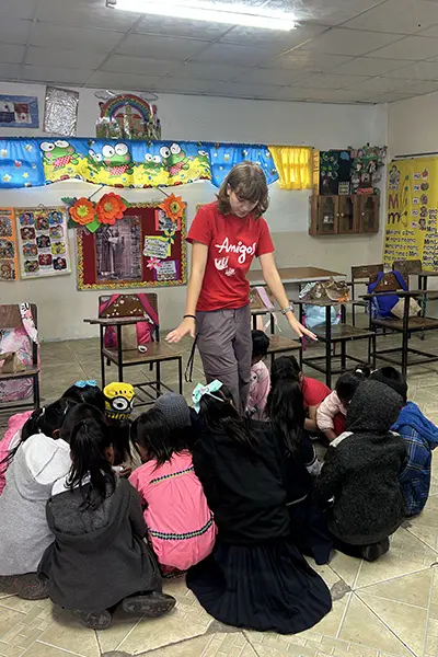 Volunteer leading an activity with children in a classroom