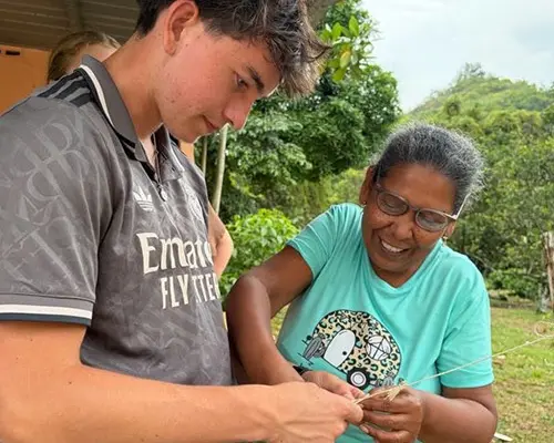 Volunteer learning to make a traditional hat