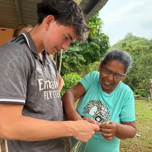Volunteer learning to make a traditional hat