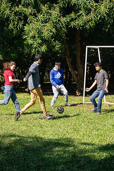 Volunteers playing soccer with local youth