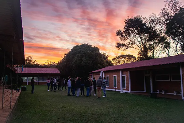 Volunteers doing briefing activities outdoors during sunset
