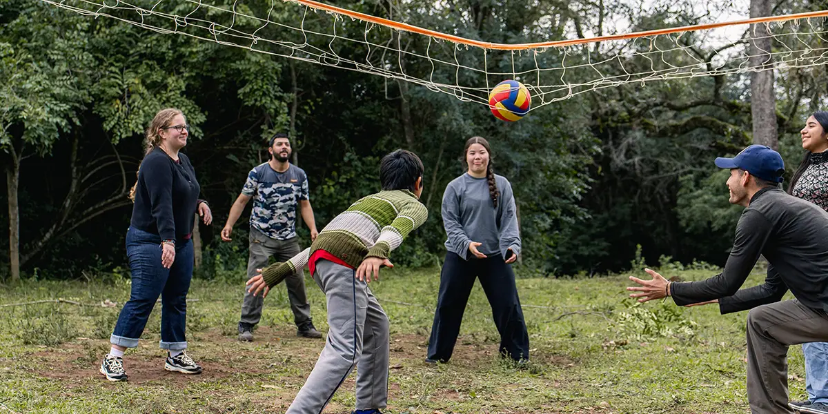 Play volleyball with local youth and kids