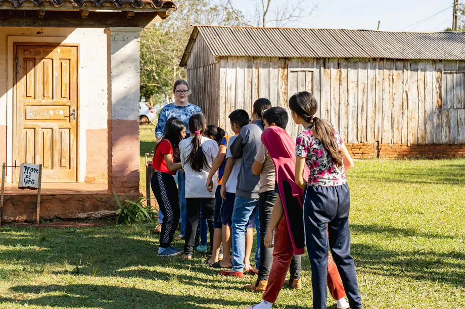 A group of kids in a line playing a game. 